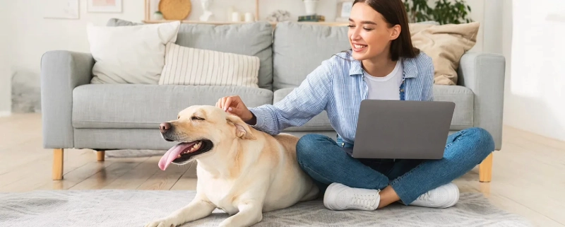 Woman with dog using laptop